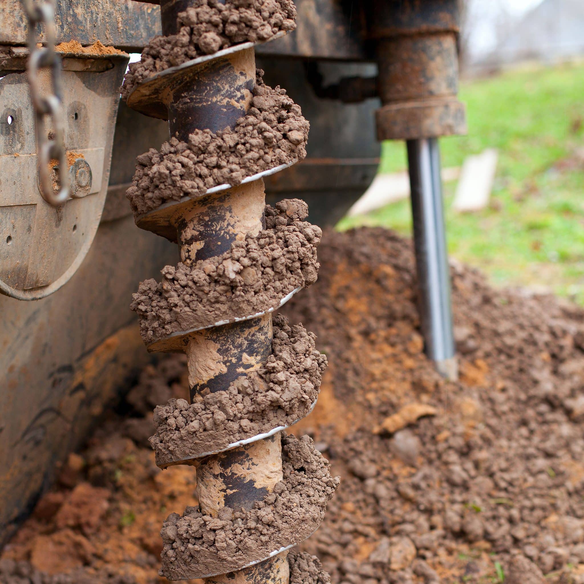 Auger drilling into soil.